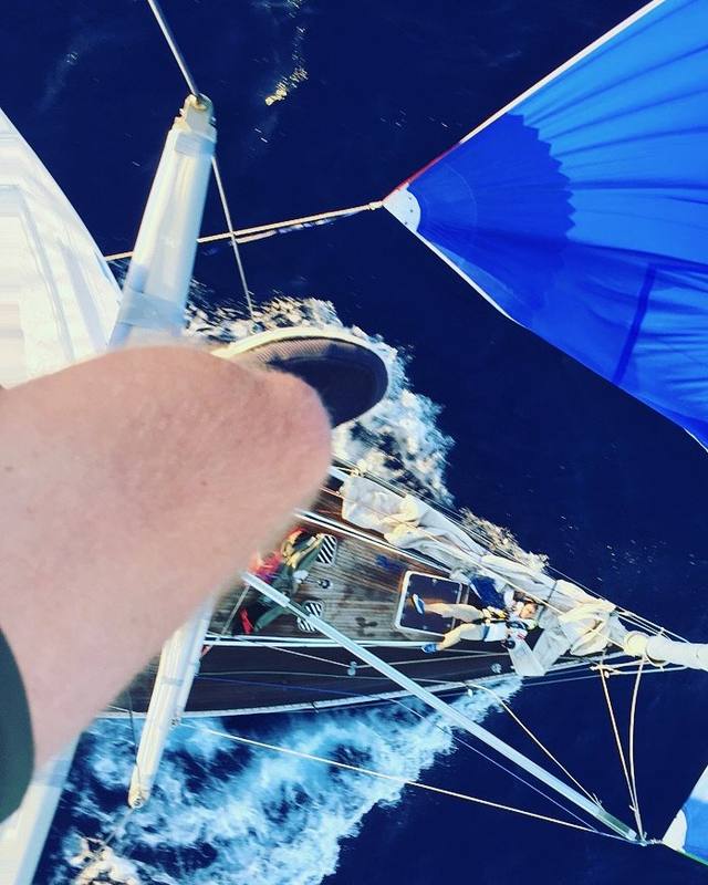 Looking straight down the mast at the deck and blue spinnaker under sail